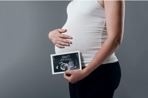 Pregnant woman with ultrasound picture