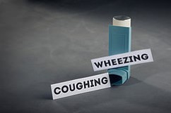 Inhaler with signs for coughing and wheezing