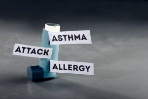 Inhaler with signs that say asthma attack allergy