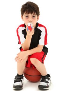 little boy with basketball using inhaler