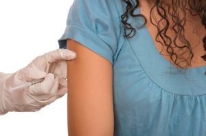 nurse giving a girl a shot in her arm