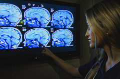 Woman examining images of the brain