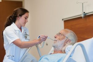 Doctor taking temperature of patient