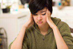 Girl experiencing a headache