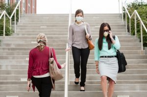 People on stairs with germ mask