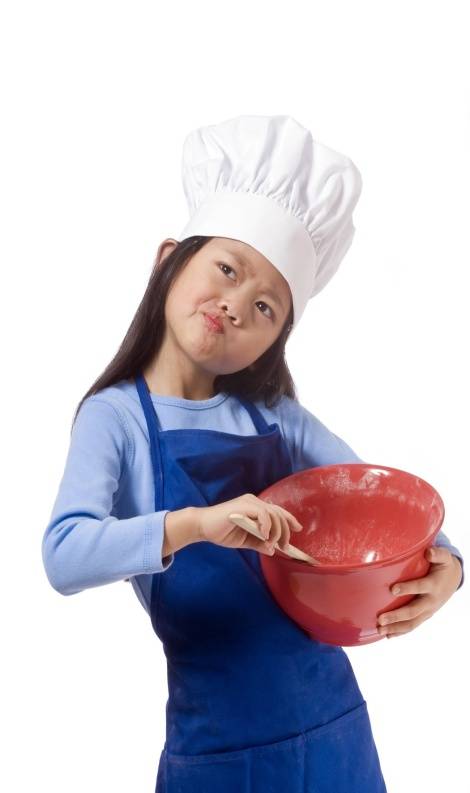 Kids Corner/Girl in Chef Outfit Holding Bowl and Spoon while Thinking