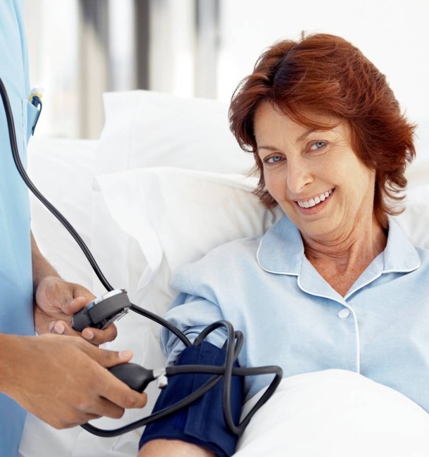 Why Exercise/Woman Having Blood Pressure Taken Photo