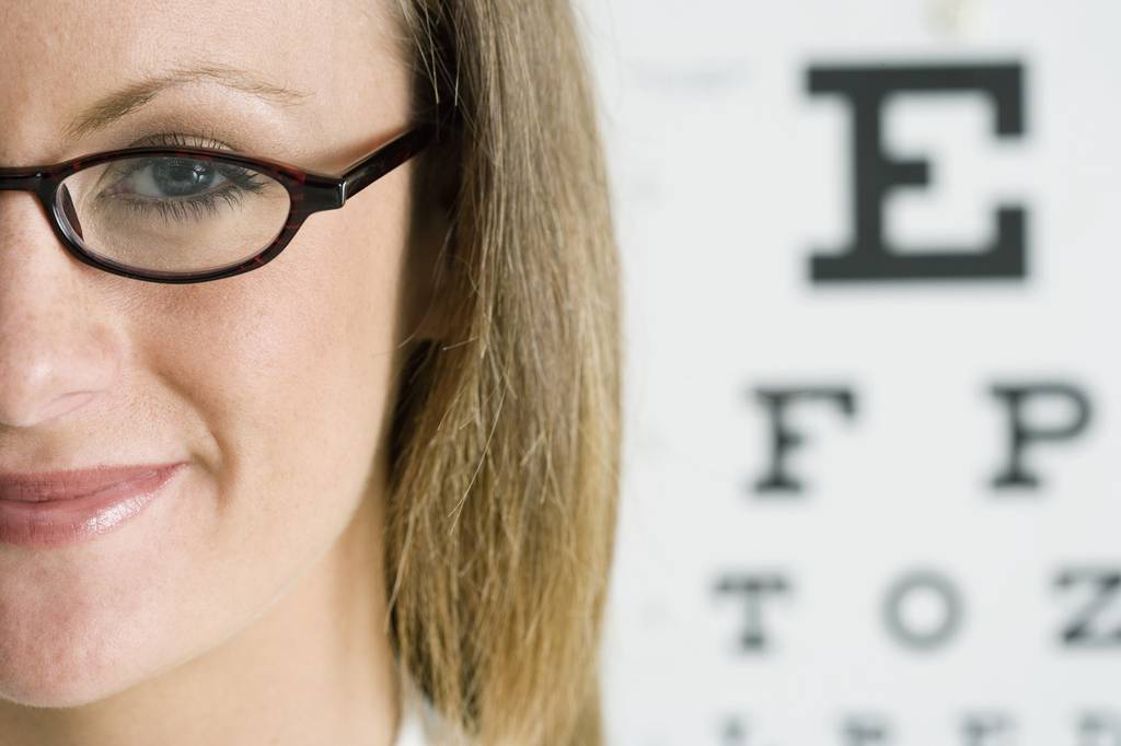 Complications/Woman Taking Blurry Vision Test Photo